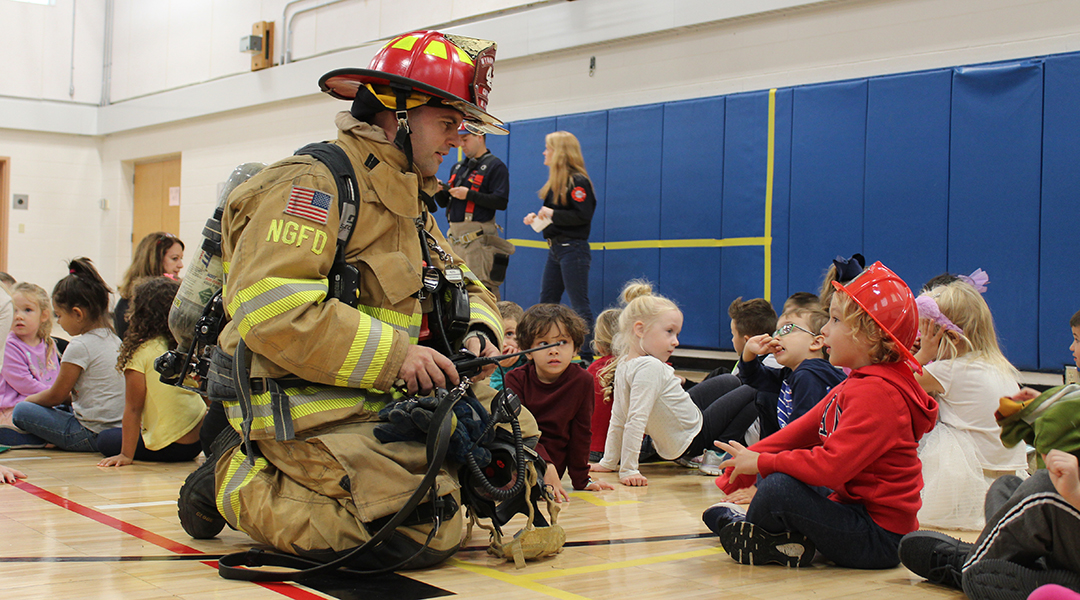 Firefighter with student