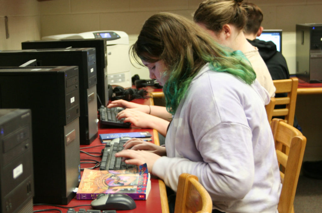 Students write in library