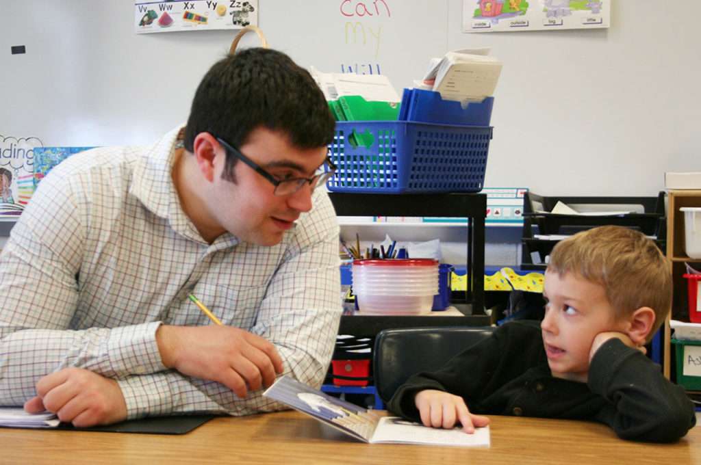 Andrew Newmark reads with student