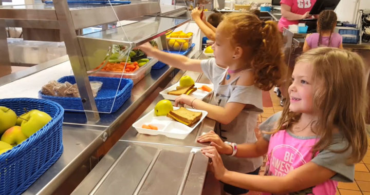 Students select vegetables in cafeteria