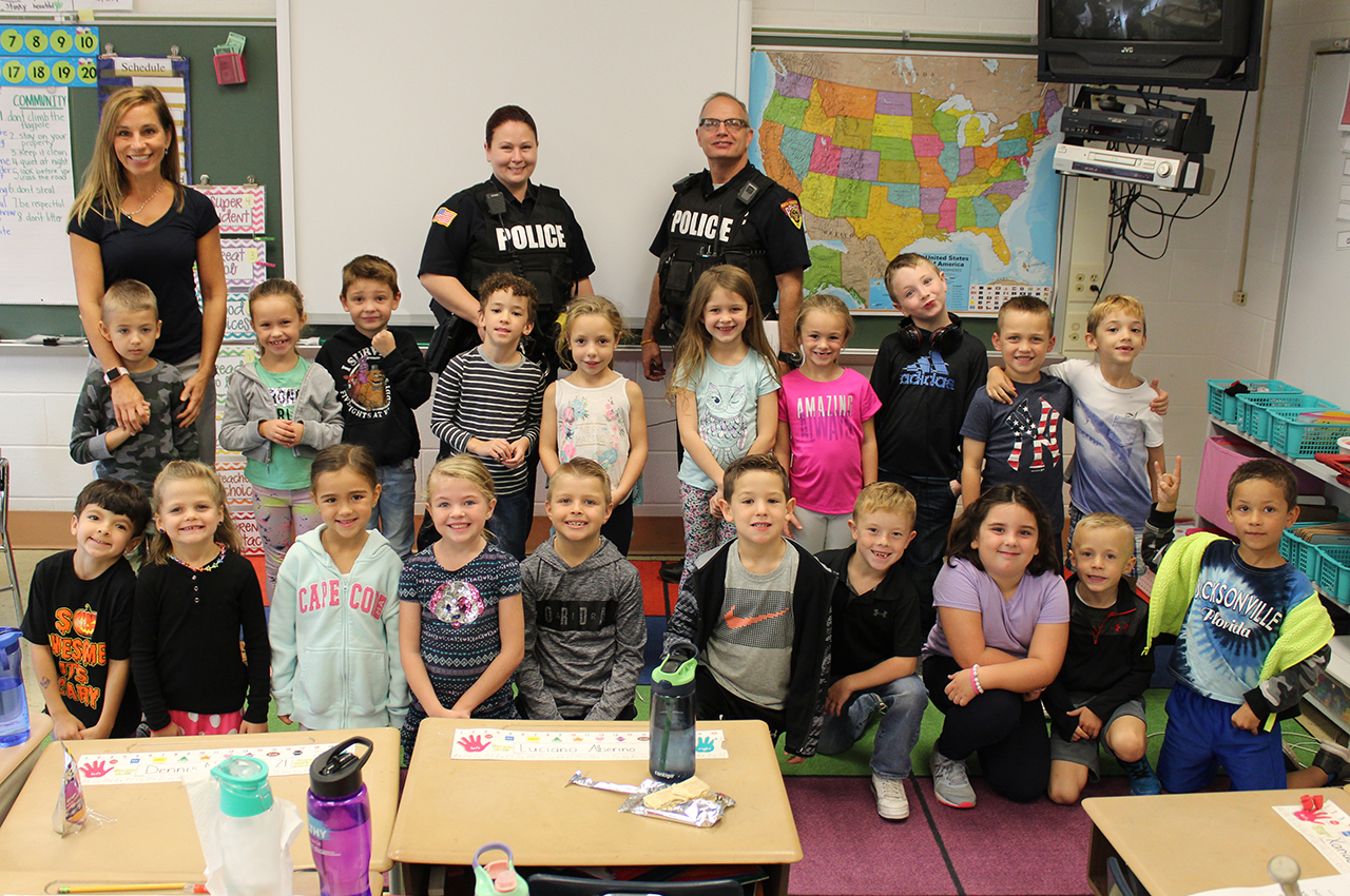 1st graders pose for photo with police
