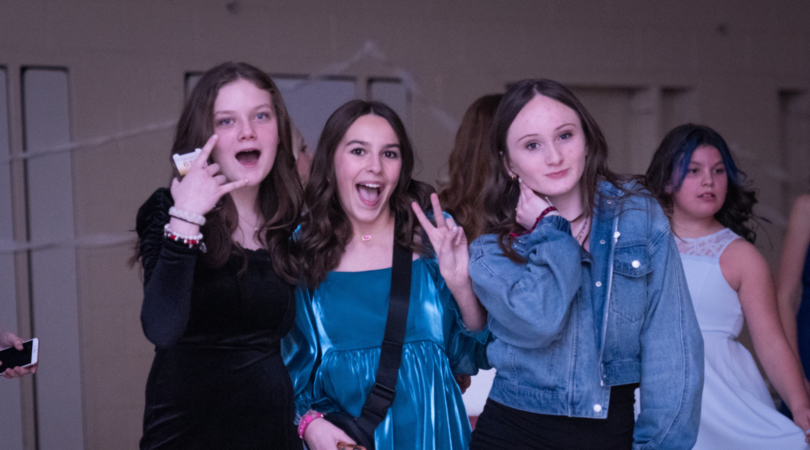 students pose for the camera at a school dance